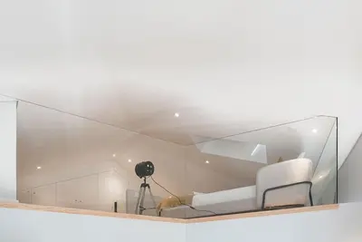 a glass room with a white couch and a camera at Cedofeita Balcony with Free Parking in Porto