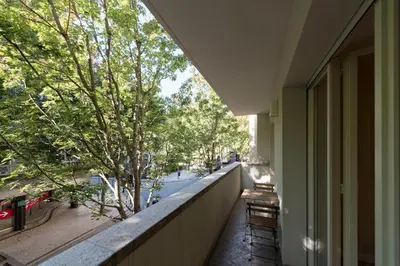 a balcony with a view of a street and trees at Luxury City Center Emporium in Porto