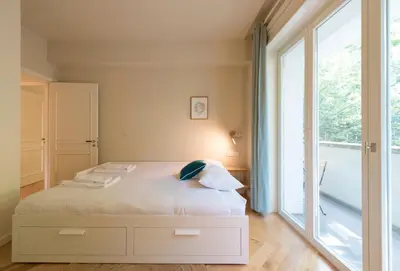 a bedroom with a bed and a large window at Luxury City Center Emporium in Porto