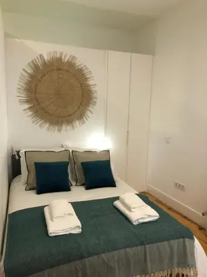 a bedroom with a large bed with two towels on it at Central charming apartment in Porto