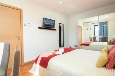 a bedroom with a bed and a tv on the wall at Magnificent Sunny Flat - Douro River in Vila Nova de Gaia