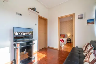 a living room with a tv and a couch at Magnificent Sunny Flat - Douro River in Vila Nova de Gaia