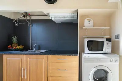 a kitchen with a washing machine and a microwave at Magnificent Sunny Flat - Douro River in Vila Nova de Gaia