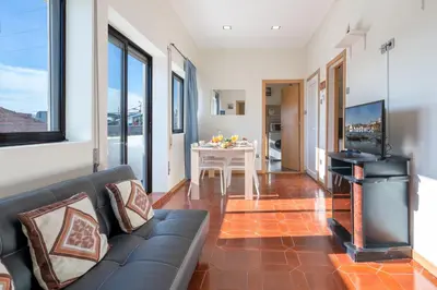 a living room with a couch and a fireplace at Magnificent Sunny Flat - Douro River in Vila Nova de Gaia