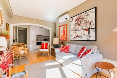 a living room with a white couch and red pillows at Oporto Viva la Vida Central apartment in Porto
