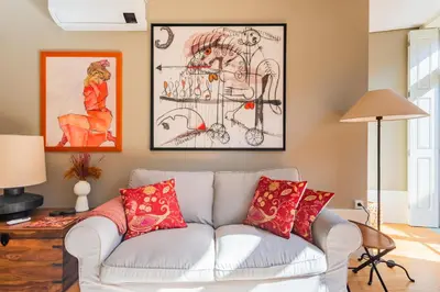 a living room with a white couch with red pillows at Oporto Viva la Vida Central apartment in Porto