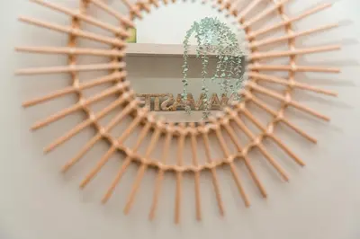 a mirror reflecting a room with a plant at GuestReady - OPortoGrow Central Batalha 2 in Porto