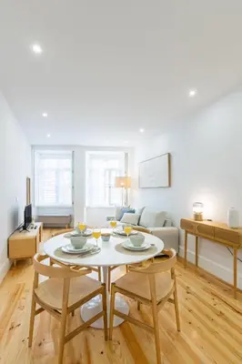 a living room with a couch and a tv at Herança dos Mercadores in Porto
