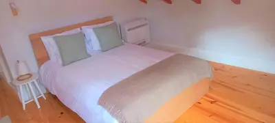 a bedroom with a large white bed with a wooden floor at A Window to Porto - Fabulous apartment by Douro River in Porto