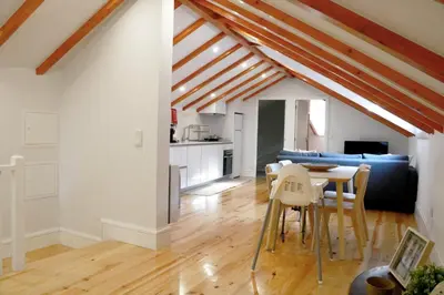 a kitchen and living room with a table and chairs at A Window to Porto - Fabulous apartment by Douro River in Porto