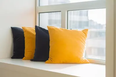 a row of yellow pillows sitting on a window sill at room Select Porto Suites in Porto