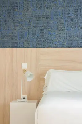 a bedroom with a bed and a lamp on a nightstand at room Select Porto Suites in Porto