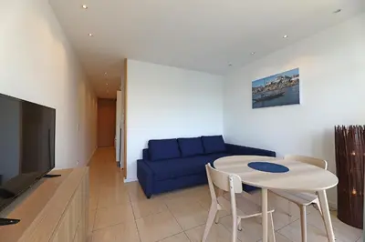 a living room with a blue couch and a table at FLH Porto Ribeira with River View in Porto
