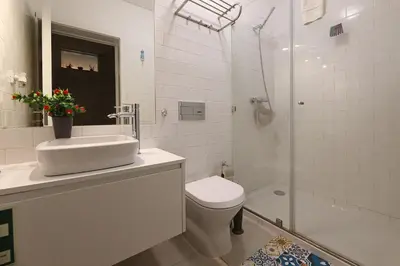 a bathroom with a toilet and a sink and a shower at FLH Porto Santa Catarina Cosy Flat in Porto