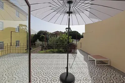 a umbrella sitting on a floor next to a building at FLH Porto Classic Apartment with Terrace & Parking in Porto