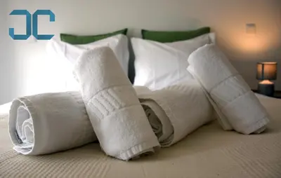 two rolled up towels on top of a bed at Sogra Apartment by JC with Balcony in Porto
