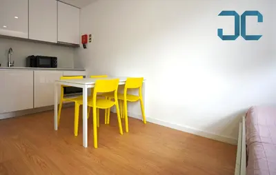 a yellow dining room table with yellow chairs in a kitchen at Sogra Apartment by JC with Balcony in Porto