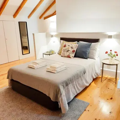 a bedroom with a large bed with towels on it at A Window to Porto St. Helena in Porto