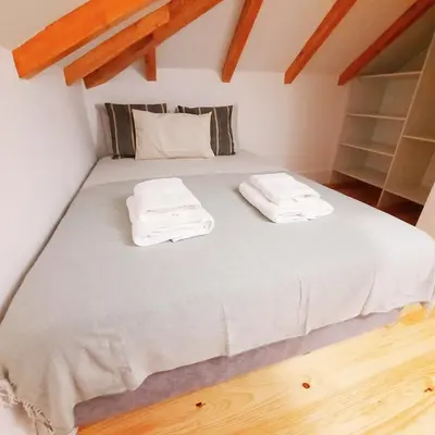 a bedroom with a bed with two towels on it at A Window to Porto St. Helena in Porto