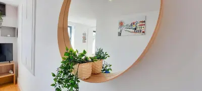 a mirror on a wall with plants in a room at A Window to Porto St. Helena in Porto