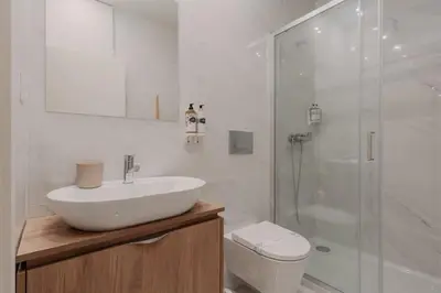 a white bathroom with a sink and a shower at Swimming Pool Luxury House, with AC Downtown Porto in Porto