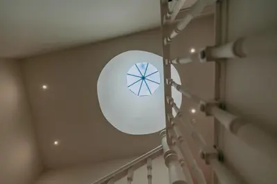 a spiral staircase with a round window in a building at Swimming Pool Luxury House, with AC Downtown Porto in Porto