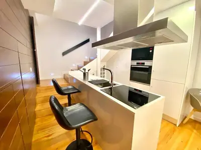 a kitchen with a counter with a sink and a stove at OHH-Padre Antonio Vieira Flat- HU in Porto