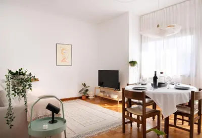 a white living room with a table and chairs at ! Bright 2BR Hammock Flat ! Praça da República in Porto