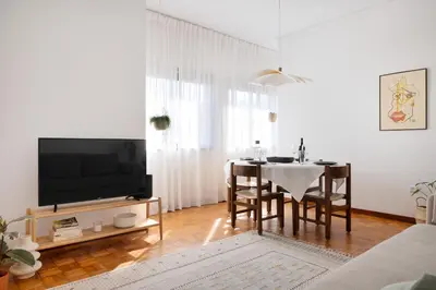 a living room with a dining table and a tv at ! Bright 2BR Hammock Flat ! Praça da República in Porto