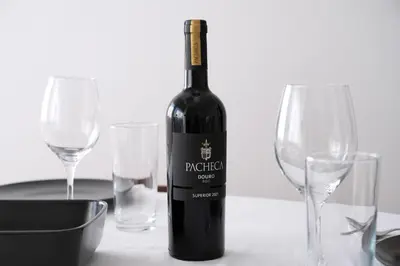 a bottle of wine sitting on a table with two glasses at ! Bright 2BR Hammock Flat ! Praça da República in Porto