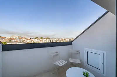 a living room with a white couch and a table at Downtown Private Rooftop Experience in Porto