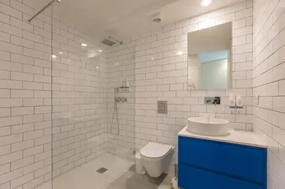 a bathroom with a sink and a toilet and a mirror at Loulé Luxury Garden W/ AC in Porto