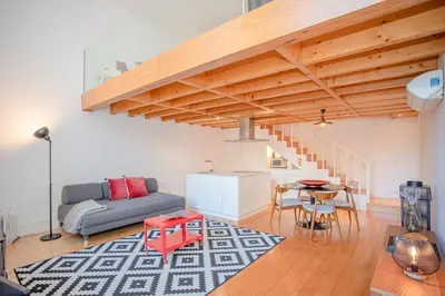 a living room with a couch and a table at Liiiving in Porto - Garden Light Mezzanine in Porto
