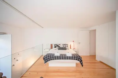a bedroom with a bed in a white room at Liiiving in Porto - Garden Light Mezzanine in Porto