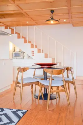 a dining room with a table and chairs and a staircase at Liiiving in Porto - Garden Light Mezzanine in Porto