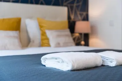 a bed with two towels sitting on top of it at GuestReady - Amazing Studio in the heart of Porto in Porto