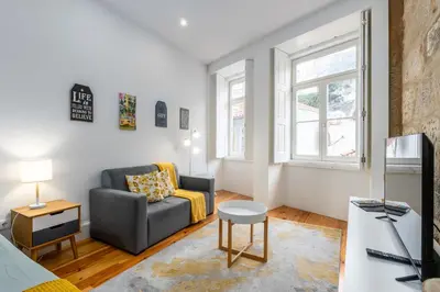 a living room with a couch and a table at A Window to Porto - Premium apartment by the River in Porto