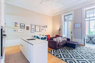 a living room with a couch and a table at Classy Flat at Marques Square with Garden in Porto