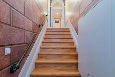 a set of stairs in a house with a broom at Classy Flat at Marques Square with Garden in Porto