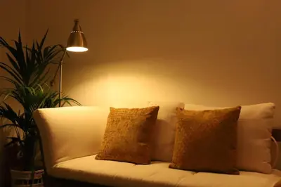 a white couch with two pillows in a living room at Nature Cosy Private House,w/AC Downtown near Metro in Porto