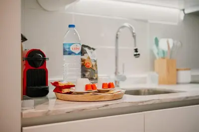 a kitchen counter with a plate of fruit and a sink at Nature Cosy Private House,w/AC Downtown near Metro in Porto