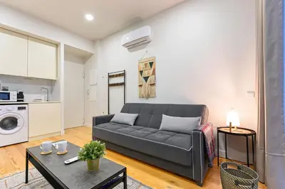 a living room with a couch and a table at BmyGuest - Patio de Santa Catarina Apartment in Porto