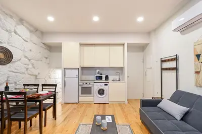 a living room with a couch and a table at BmyGuest - Patio de Santa Catarina Apartment in Porto
