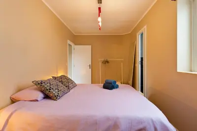 a bedroom with a large bed with a teddy bear on it at Oporto Blue Lapa - Spacious Family Apartment With Winter Garden in Porto