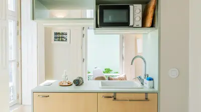 a kitchen with a sink and a microwave at Barros Lima 493 by LovelyStay in Porto
