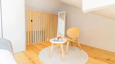 a small table and a chair in a room at Barros Lima 493 by LovelyStay in Porto