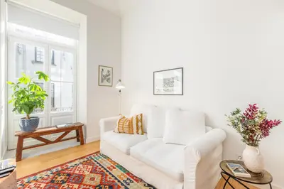 a white living room with a white couch at Welcome Aliados a Noble apartment in City Heart in Porto