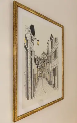 a drawing of a city street in a gold frame at Welcome Aliados a Noble apartment in City Heart in Porto