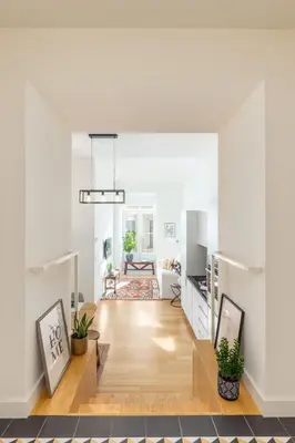 a living room with white walls and a wooden floor at Welcome Aliados a Noble apartment in City Heart in Porto