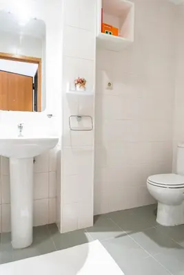 a kitchen with a stove and wooden cabinets at Lovely Cedofeita Apartment by Unique Hosts in Porto